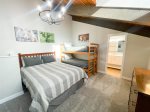 Loft with a queen bed and twin bunk bed set